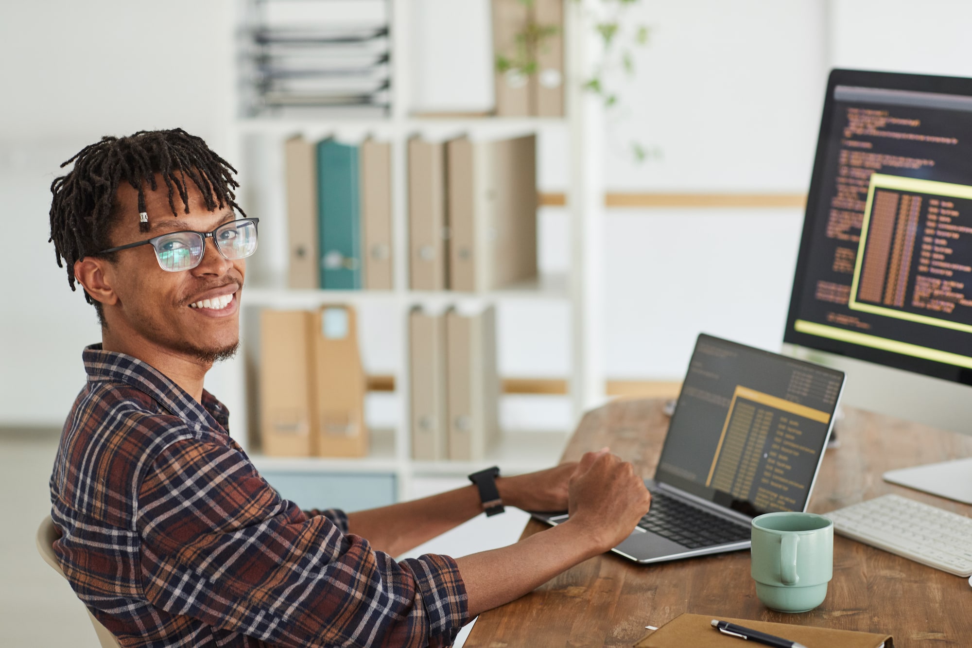 Man programming at desk