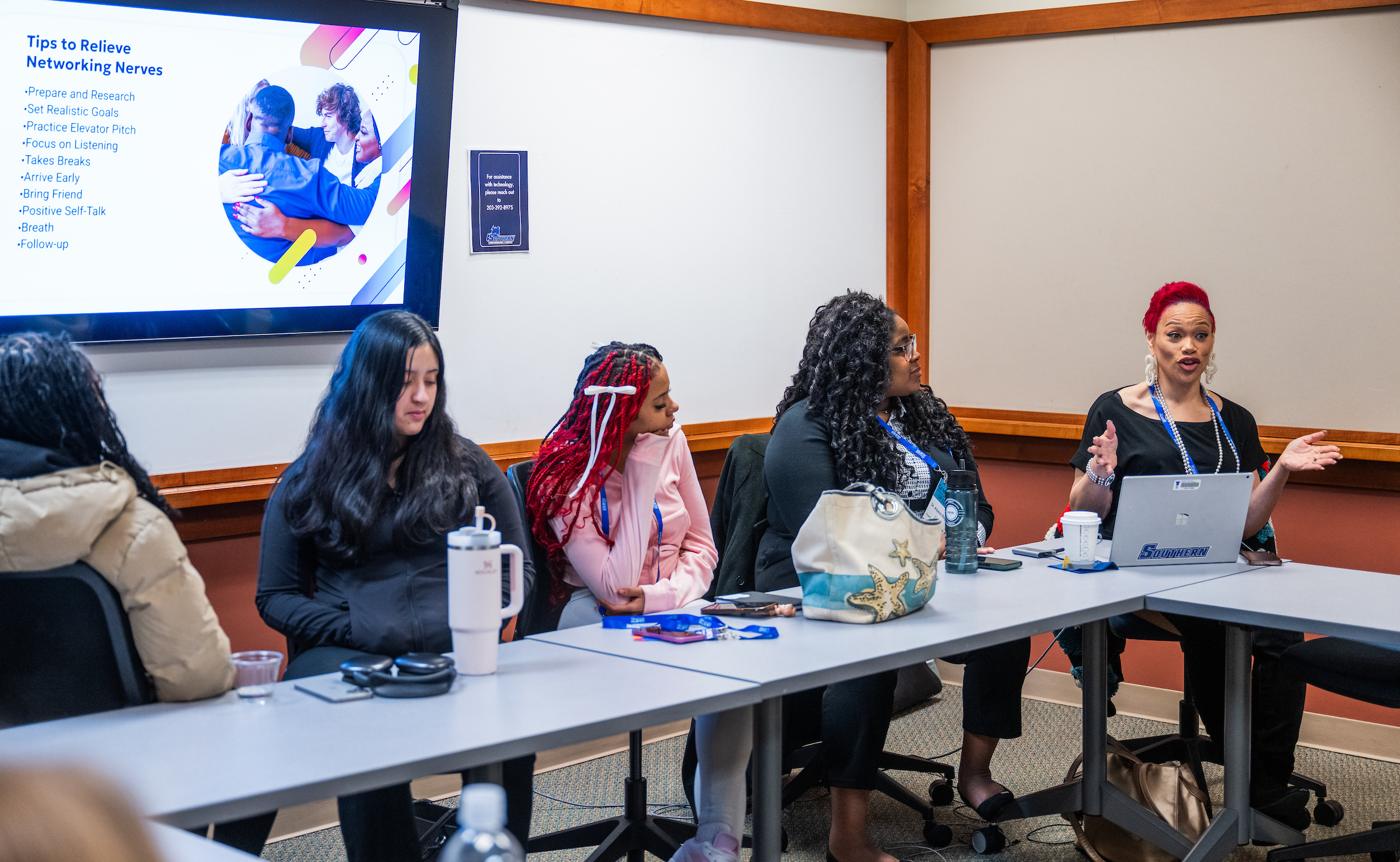 students sitting in a breakout room session