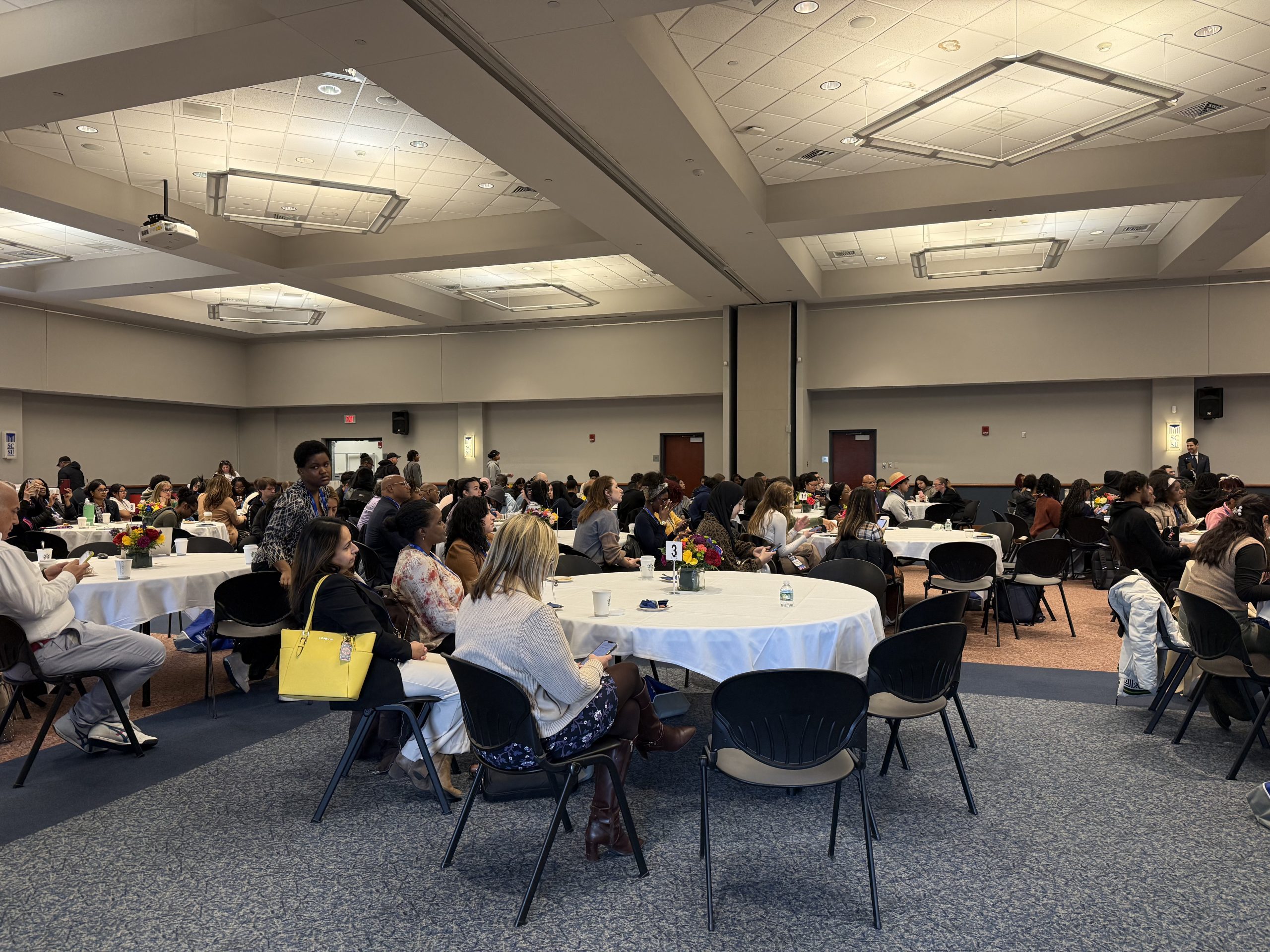 conference room full of attendees sitting at tables