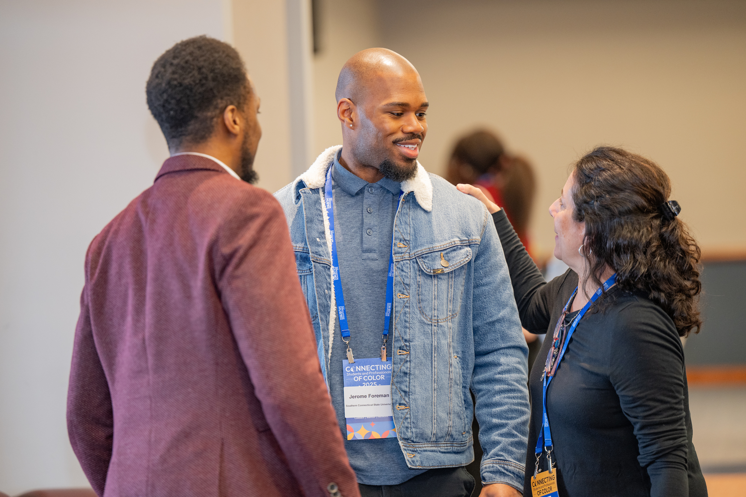 three adult attendees conversing