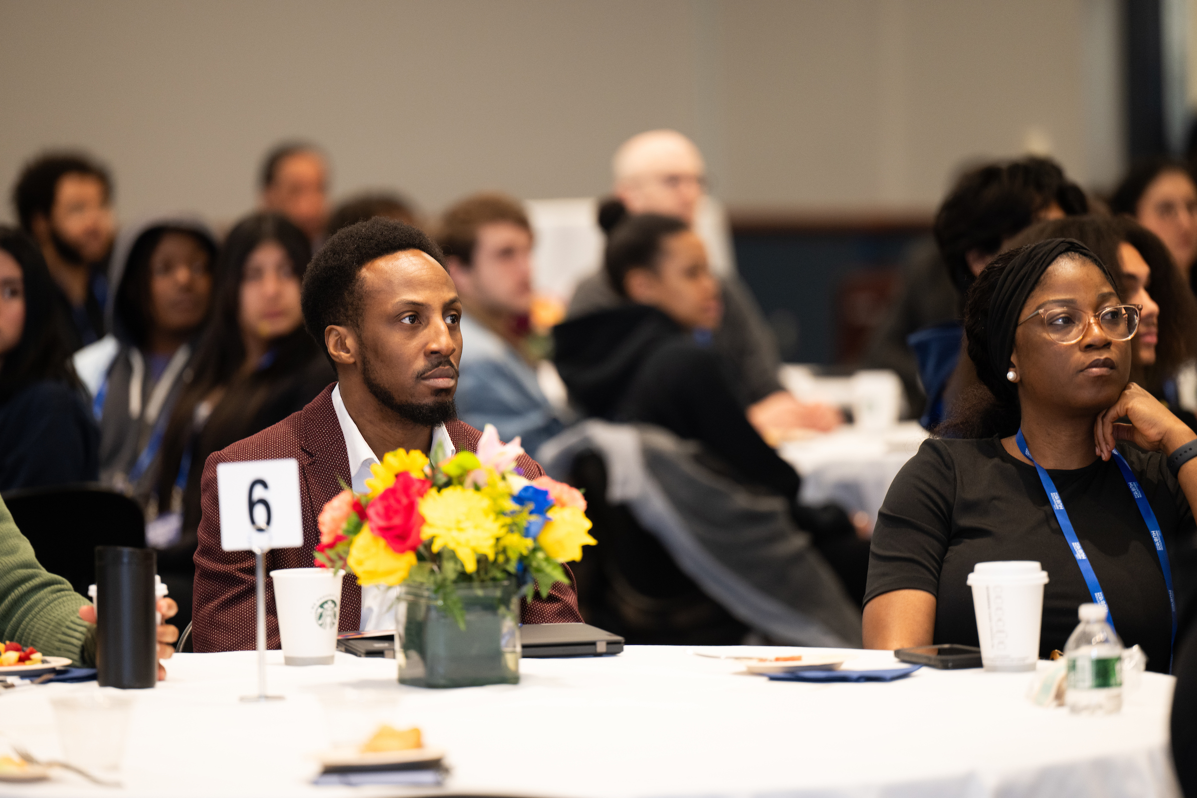 a table of attendees looking at the stage