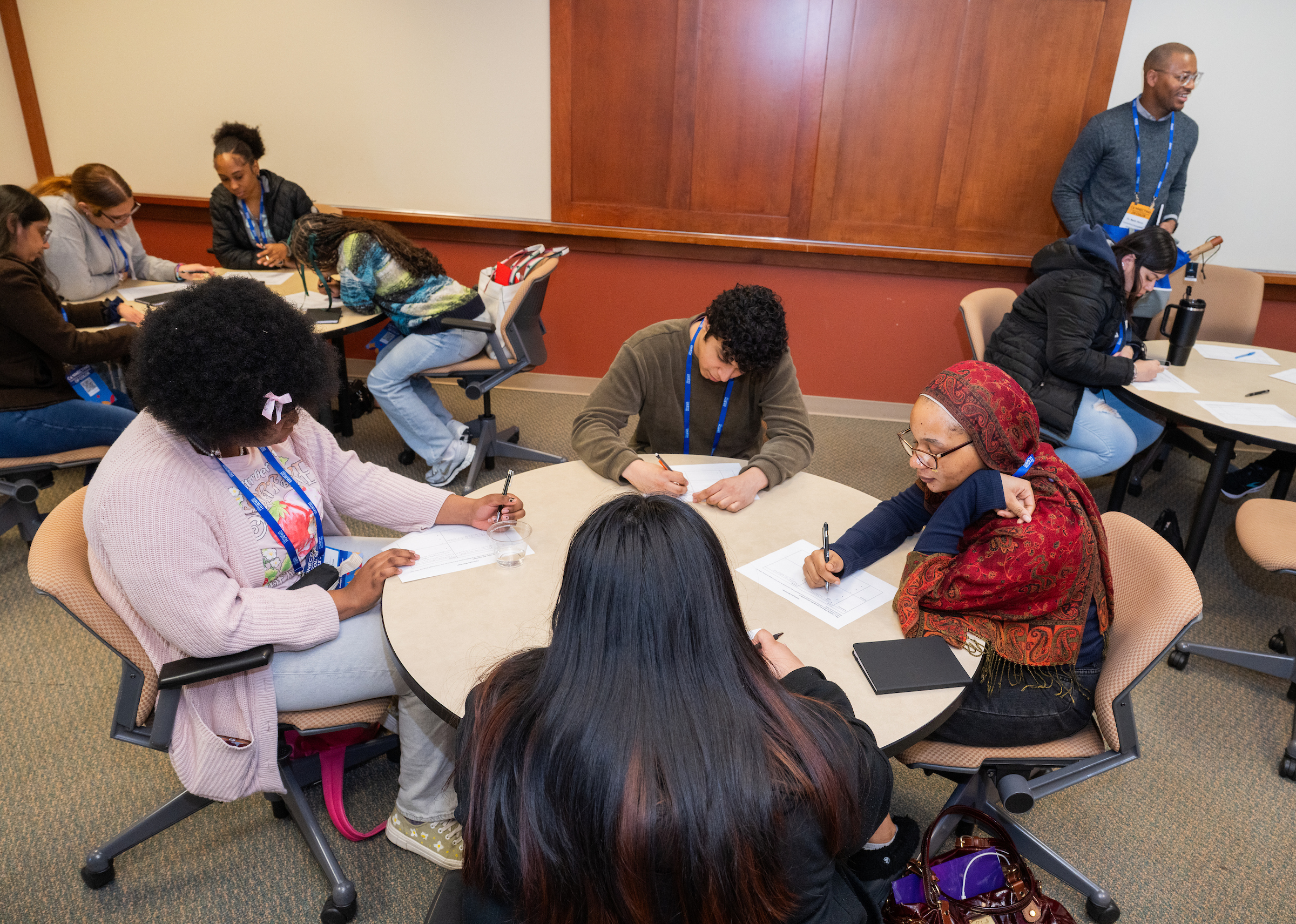 students writing during a workshop at a table